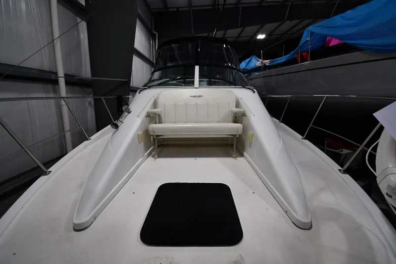 Slide: The Image of 2000 Carver 350 Mariner boat in storage, featuring a spacious deck and seating area. - 1