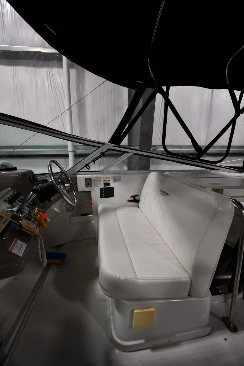 Slide: The Image of Interior of 2000 Carver 350 Mariner boat with white seating and steering wheel. - 10
