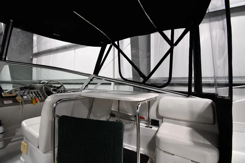Slide: The Image of Interior view of 2000 Carver 350 Mariner yacht, featuring helm and seating area. - 11