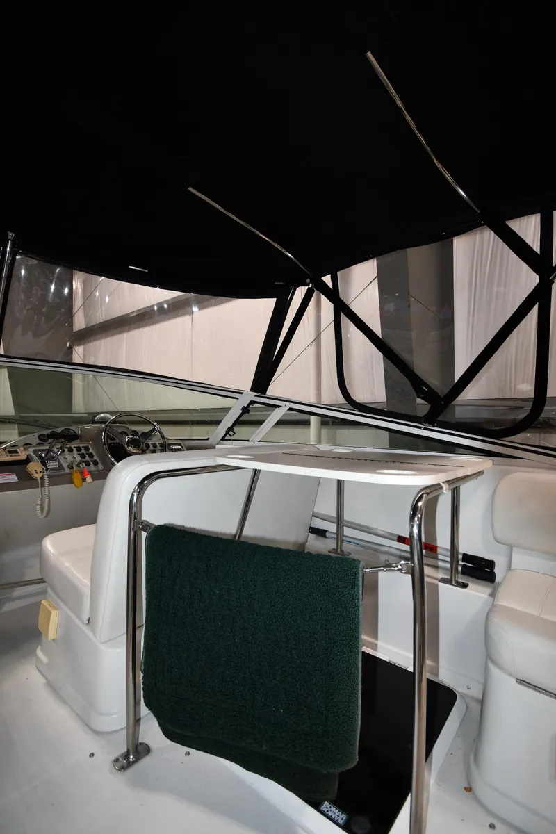 Slide: The Image of Interior view of 2000 Carver 350 Mariner boat with seating and steering area. - 12