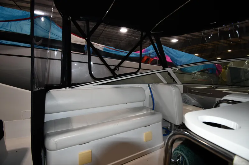 Slide: The Image of 2000 Carver 350 Mariner interior with seating and canopy in a boat showroom. - 13