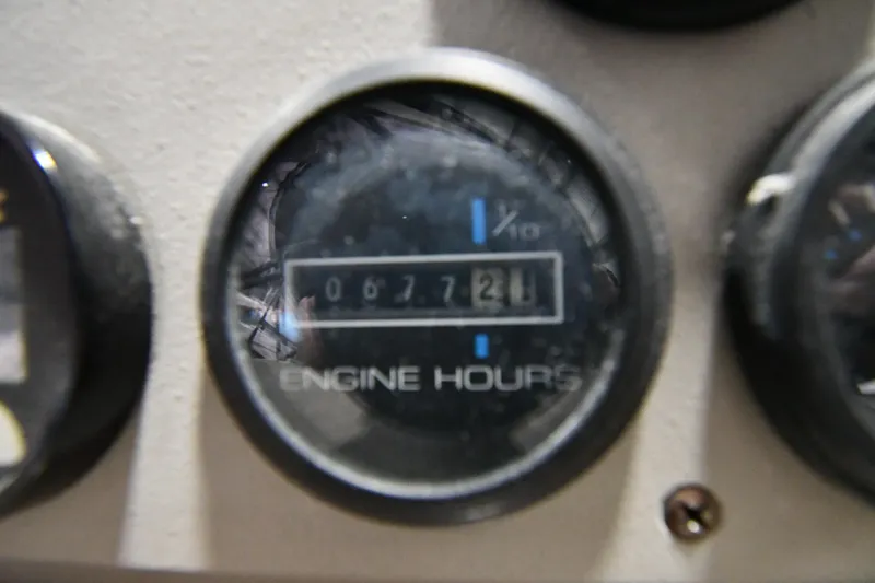 Slide: The Image of Close-up of Carver 350 Mariner 2000 engine hours gauge showing 672.1 hours. - 15