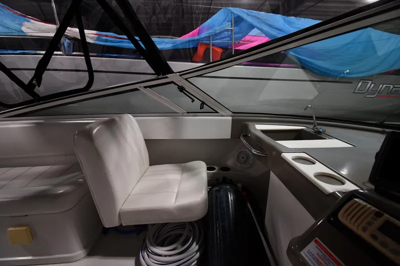 Slide: The Image of Interior of 2000 Carver 350 Mariner boat with seating and control panel. - 18
