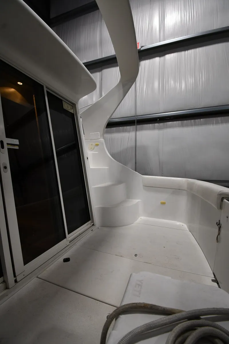 Slide: The Image of 2000 Carver 350 Mariner yacht interior with stairs and sliding doors in a storage facility. - 21