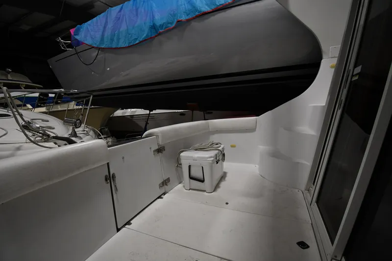 Slide: The Image of 2000 Carver 350 Mariner yacht interior with storage and cooler, docked indoors. - 23