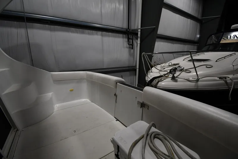 Slide: The Image of 2000 Carver 350 Mariner yacht interior in storage, featuring deck and mooring lines. - 24