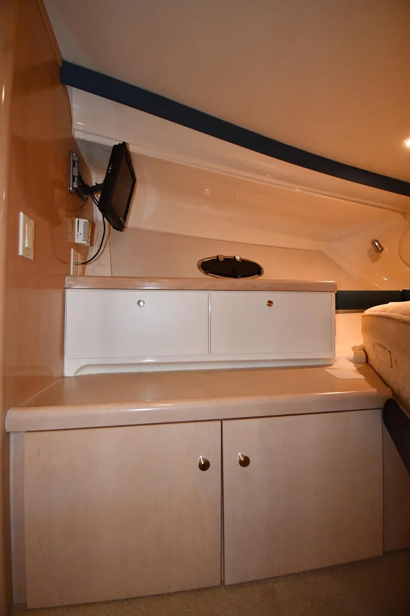 Slide: The Image of 2000 Carver 350 Mariner interior with cabinets and mounted TV. - 30
