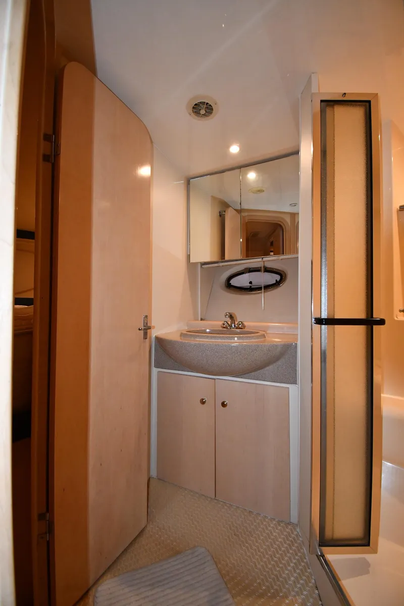 Slide: The Image of 2000 Carver 350 Mariner bathroom with sink, mirror, and shower. - 36
