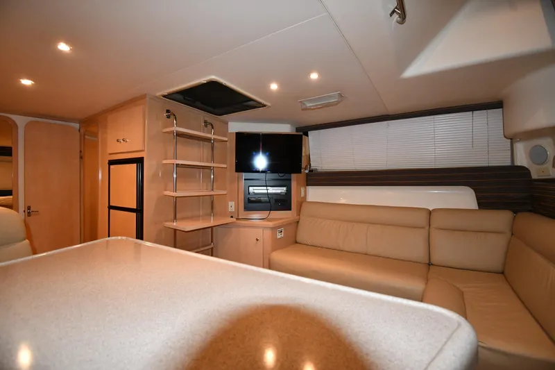 Slide: The Image of Interior of 2000 Carver 350 Mariner yacht with beige seating and modern amenities. - 37