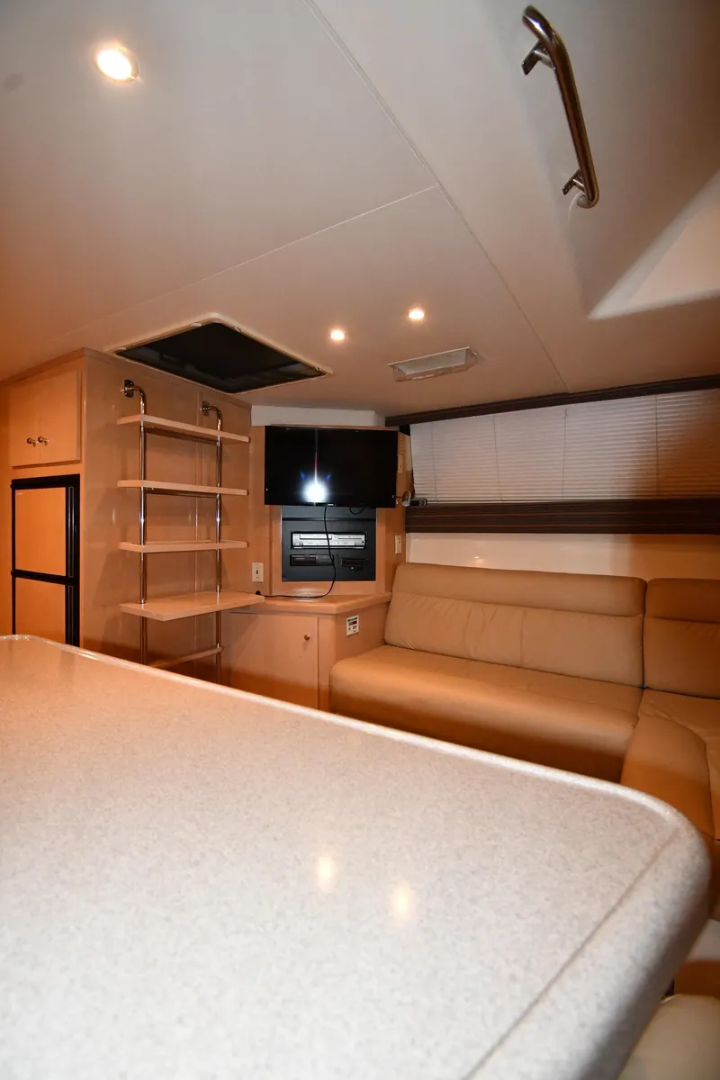 Slide: The Image of Interior of 2000 Carver 350 Mariner yacht with beige seating and modern amenities. - 38