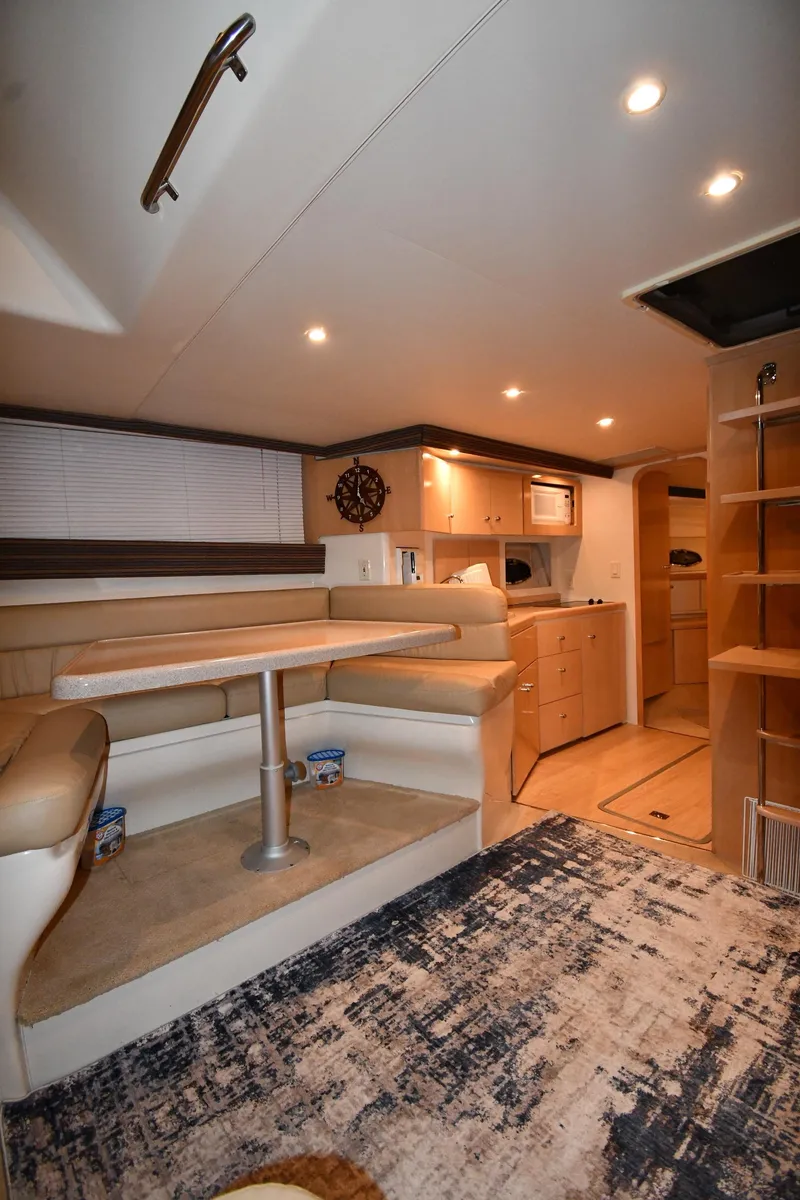 Slide: The Image of Interior of 2000 Carver 350 Mariner yacht with dining area and kitchenette. - 40