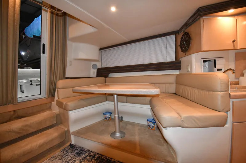 Slide: The Image of Interior of 2000 Carver 350 Mariner yacht with beige seating and dining area. - 41