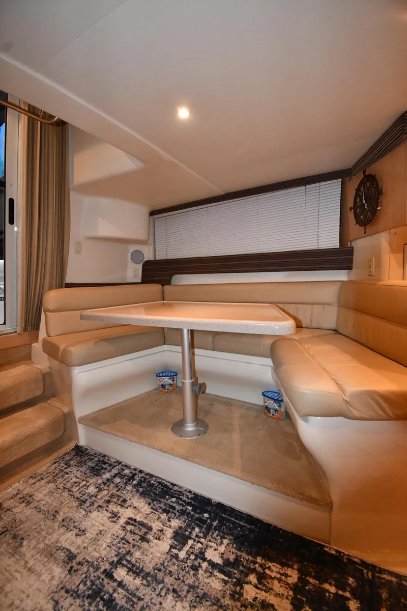 Slide: The Image of Interior of 2000 Carver 350 Mariner yacht with cozy dining area and plush seating. - 42
