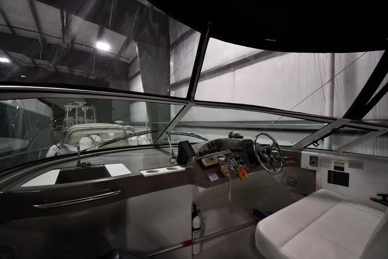 Slide: The Image of Interior view of 2000 Carver 350 Mariner yacht cockpit in a dimly lit storage facility. - 6
