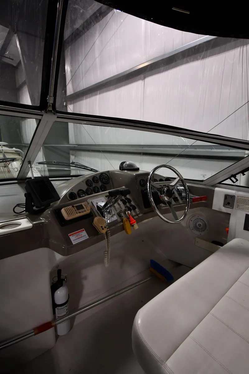 Slide: The Image of Interior view of 2000 Carver 350 Mariner boat cockpit with steering wheel and controls. - 8