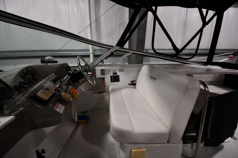 Slide: The Image of Interior of 2000 Carver 350 Mariner boat with white seating and control panel. - 9