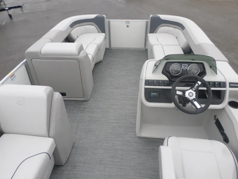 Slide: The Image of 2025 Godfrey Sweetwater 2086 CSE pontoon boat interior with plush seating and modern dashboard. - 6