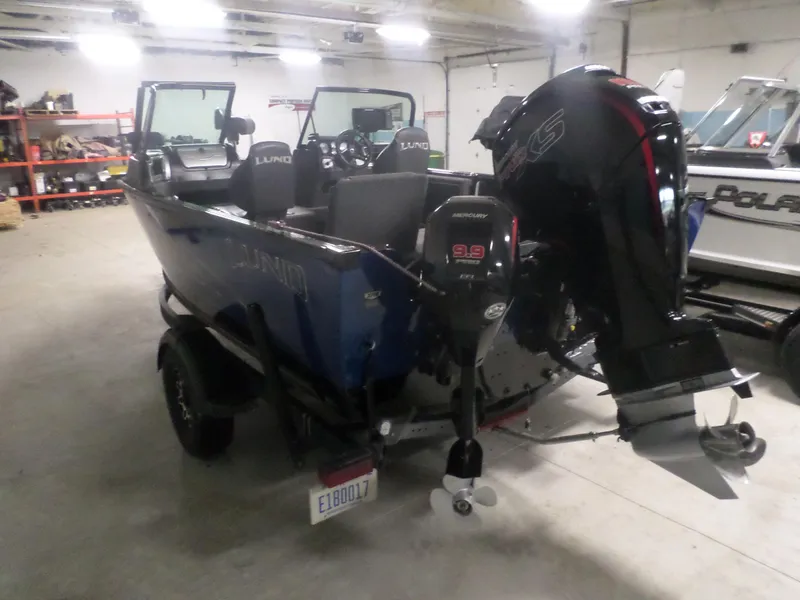 Slide: The Image of 2020 Lund IMPACT 1775 XS boat with Mercury outboard motor in a garage setting. - 5