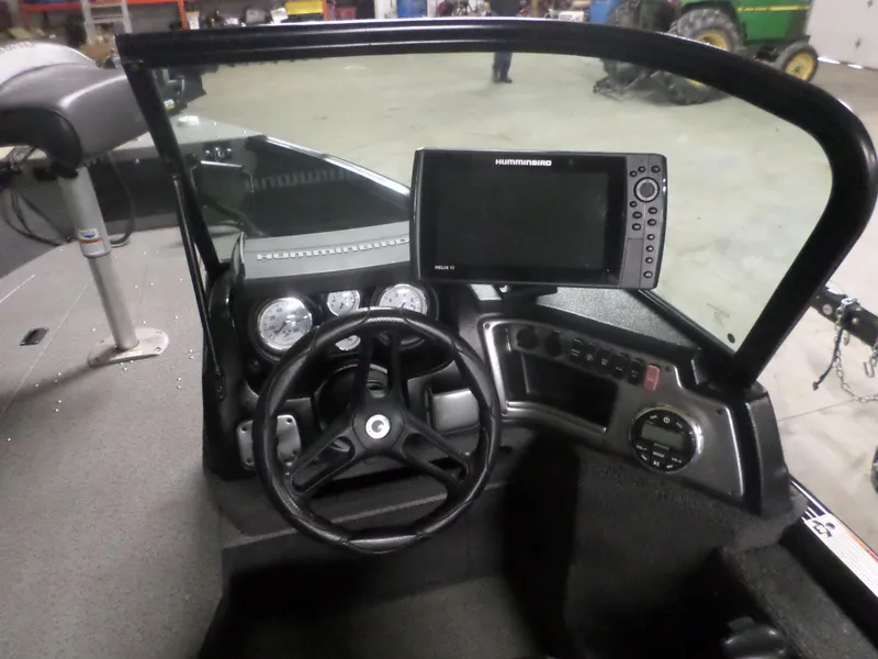 Slide: The Image of 2020 Lund IMPACT 1775 XS boat dashboard with steering wheel and Humminbird fish finder. - 6