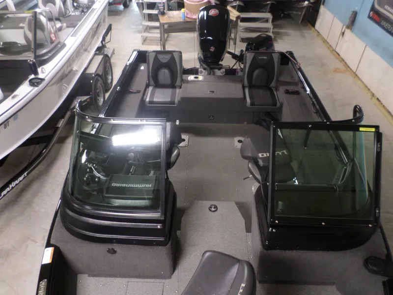 Slide: The Image of 2020 Lund IMPACT 1775 XS boat interior with seating and windshield in a showroom. - 7