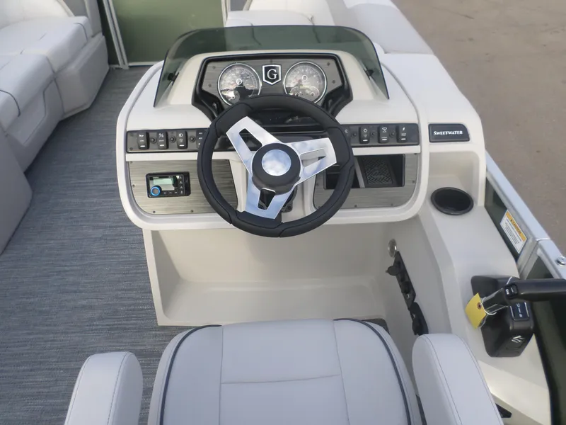 Slide: The Image of 2025 Godfrey Sweetwater 2086 SB boat dashboard with steering wheel and controls. - 3