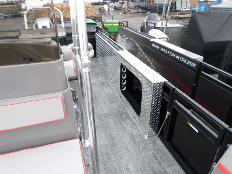 Slide: The Image of 2024 Angler Quest 8522/24 Pro Fish N Cruise boat interior with seating and storage. - 2