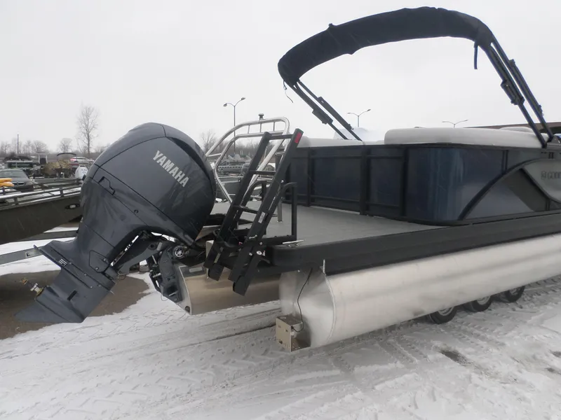 Slide: The Image of 2025 Godfrey Sweetwater 2286SB Tri pontoon boat with Yamaha outboard motor on snowy ground. - 4