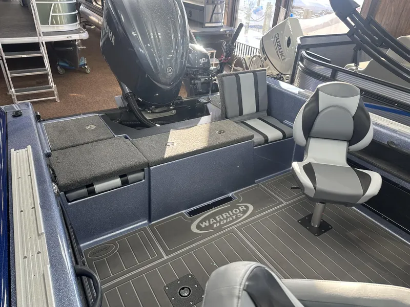 Slide: The Image of 2025 Warrior 208 DC boat interior with Yamaha engine and modern seating. - 2