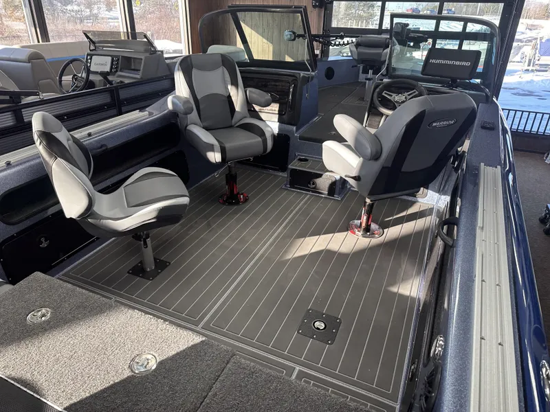 Slide: The Image of 2025 Warrior 208 DC boat interior with modern seating and navigation equipment. - 5