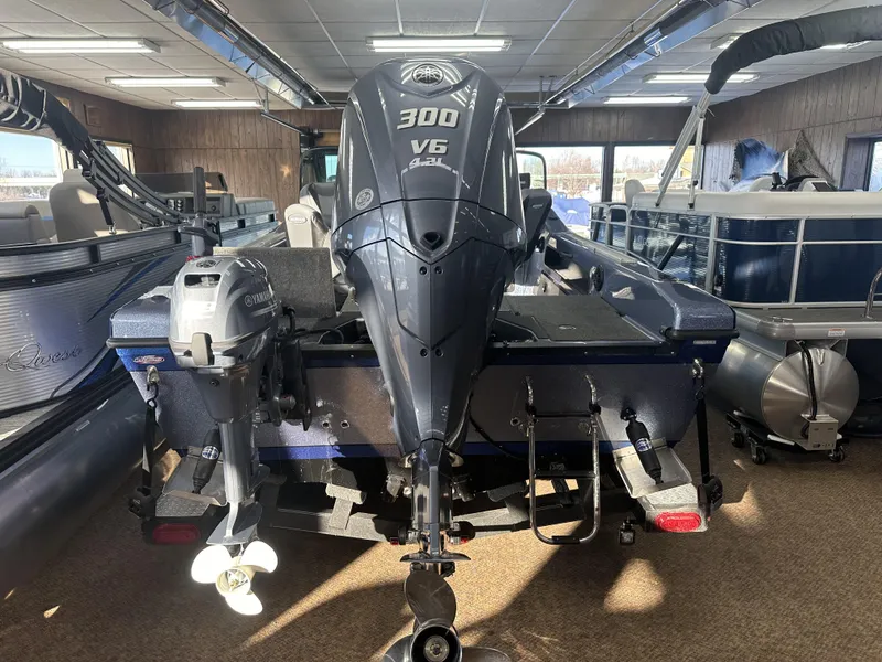 Slide: The Image of 2025 Warrior 208 DC boat with Yamaha 300 V6 outboard motor in showroom. - 6