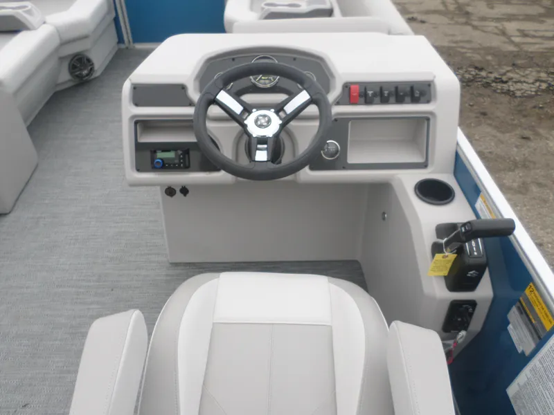 Slide: The Image of 2025 Godfrey Experience 2286 SBX boat helm with steering wheel and control panel. - 5