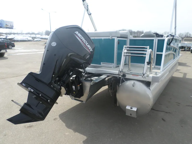 Slide: The Image of 2025 Princecraft Vectra 21 L pontoon boat with Mercury outboard motor, parked on pavement. - 5