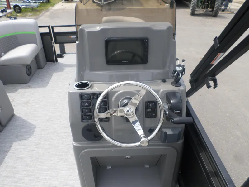 Slide: The Image of 2024 Angler Quest 8524 Family Fish Pro RA boat console with steering wheel and controls. - 3