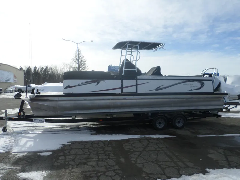 Slide: The Image of 2024 Angler Quest 8524/26 Pro Fish N Cruise pontoon boat on trailer, snowy background. - 1