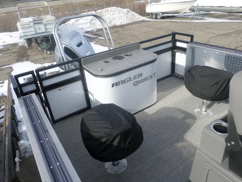Slide: The Image of 2024 Angler Quest 8524/26 Pro Fish N Cruise boat interior with covered seats and fishing station. - 5