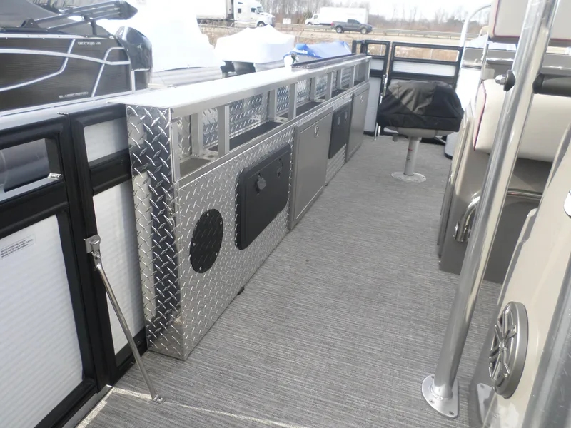 Slide: The Image of 2024 Angler Quest 8524/26 Pro Fish N Cruise boat interior with diamond plate storage. - 8