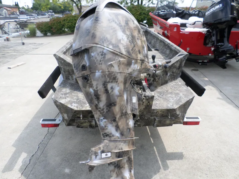 Slide: The Image of Camouflage-patterned Excel 1751 Viper boat, 2023 model, with outboard motor, parked on concrete. - 4