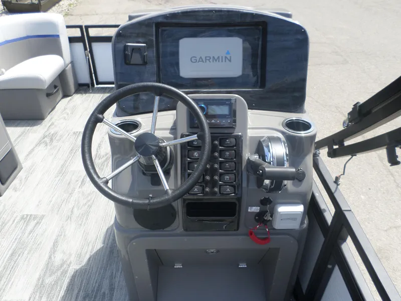 Slide: The Image of 2024 Angler Quest 8522 Pro Family Fish L boat console with Garmin display and steering wheel. - 3