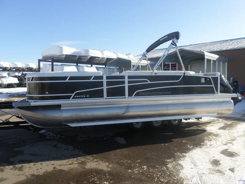 Slide: The Image of 2024 Princecraft Vectra 23 L TRI pontoon boat on a snowy lot. - 1