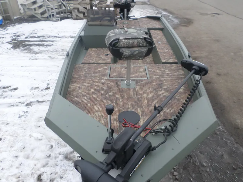 Slide: The Image of 2023 Polar Kraft Sportsman 1754 SC boat with camouflage seating and trolling motor. - 2