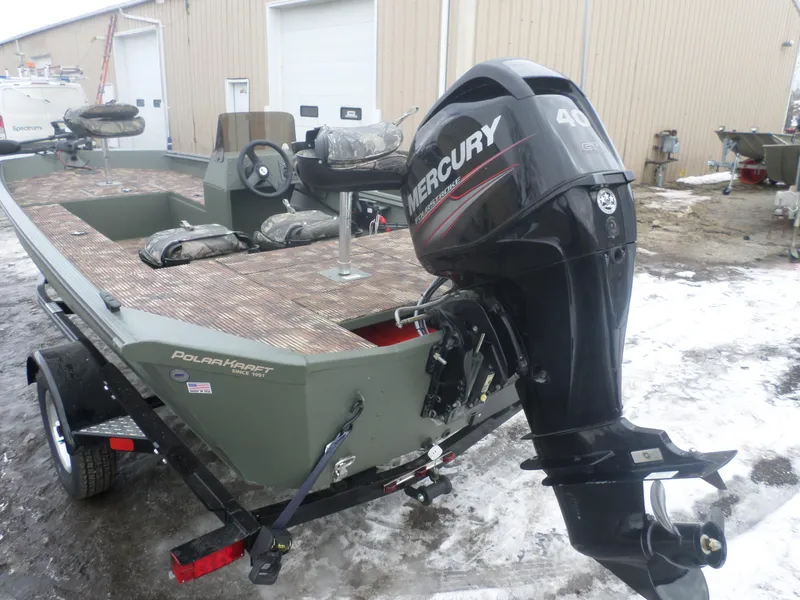 Slide: The Image of 2023 Polar Kraft Sportsman 1754 SC boat with Mercury outboard motor, parked on snowy ground. - 5