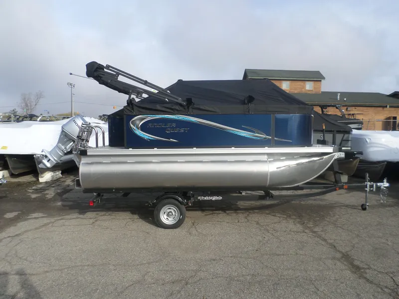 Slide: The Image of 2025 Angler Quest 814 Panfish boat on trailer, covered and parked outdoors. - 1
