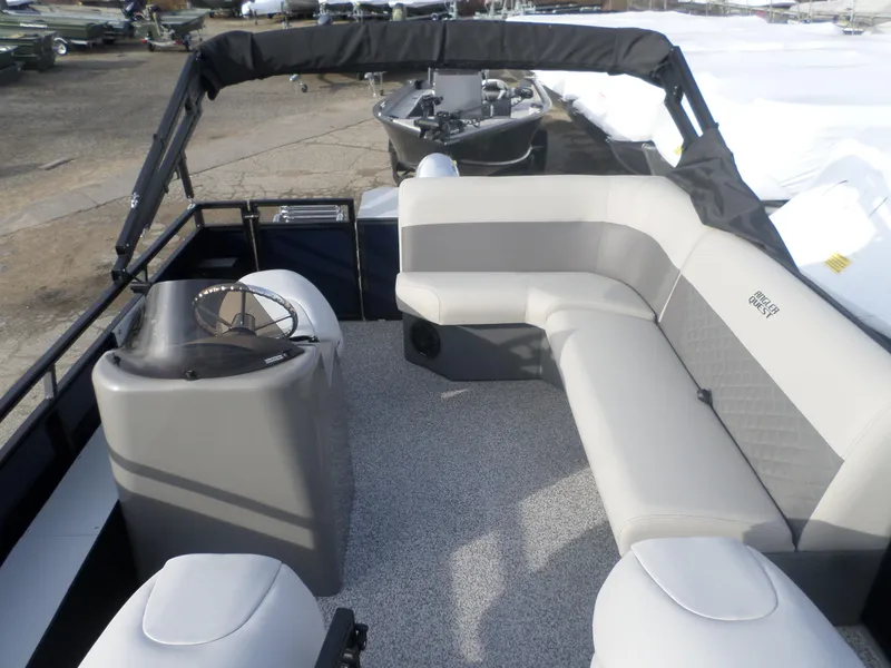 Slide: The Image of 2025 Angler Quest 814 Panfish boat interior with gray seating and steering console. - 2
