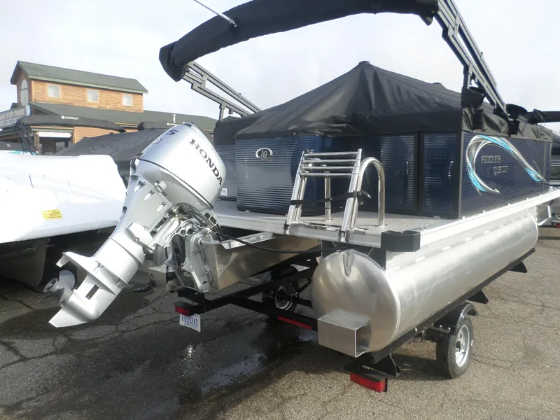 Slide: The Image of 2025 Angler Quest 814 Panfish pontoon boat with Honda outboard motor, parked outdoors. - 6