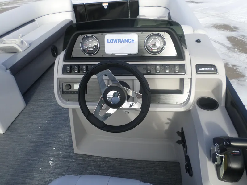 Slide: The Image of 2025 Godfrey Sweetwater 2286SB Tri boat dashboard with steering wheel and control panel. - 5