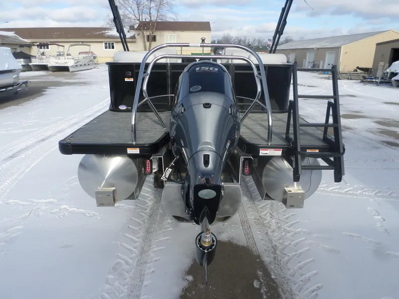 Slide: The Image of 2025 Godfrey Sweetwater 2286SB Tri pontoon boat with powerful outboard motor in snowy marina. - 6