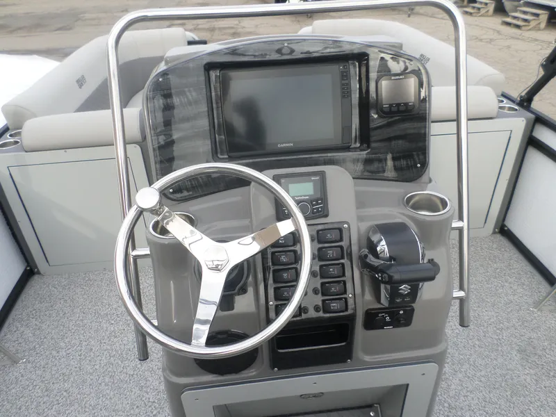 Slide: The Image of 2025 Angler Quest 8524 Pro Troll boat dashboard with steering wheel and navigation controls. - 4