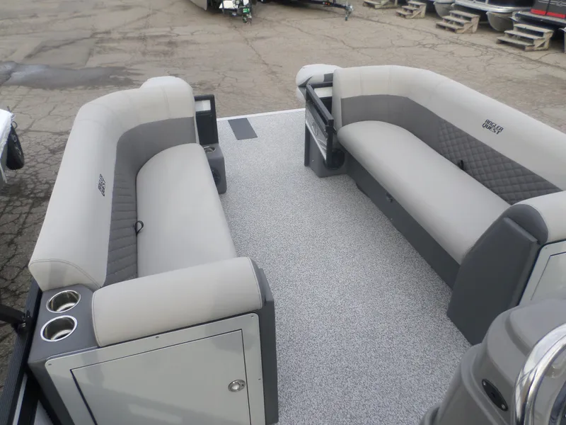 Slide: The Image of 2025 Angler Quest 8524 Pro Troll boat interior with gray seating and cup holders. - 5