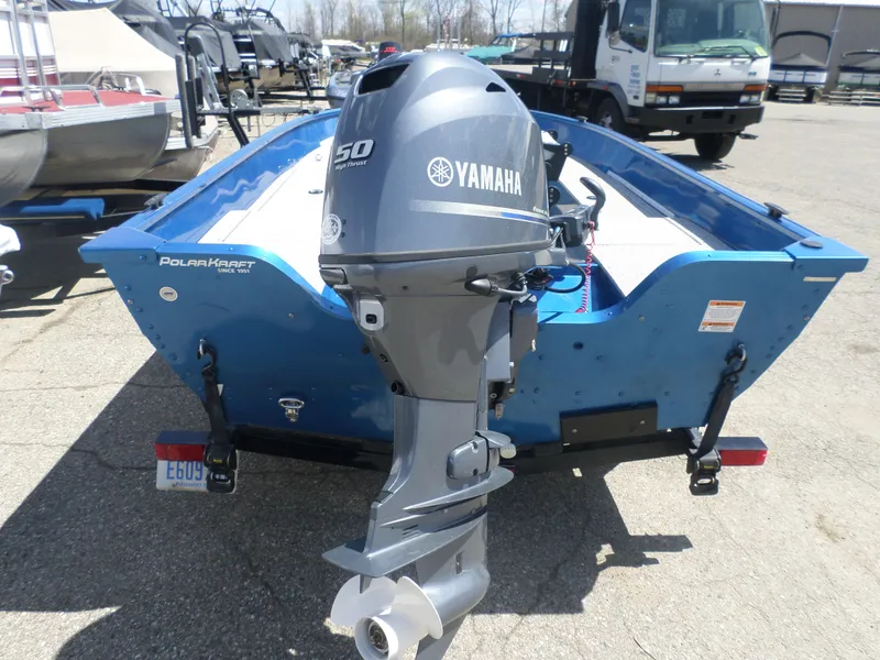 Slide: The Image of 2021 Polar Kraft OLV 156 T boat with Yamaha 50 HP outboard motor, parked outdoors. - 4