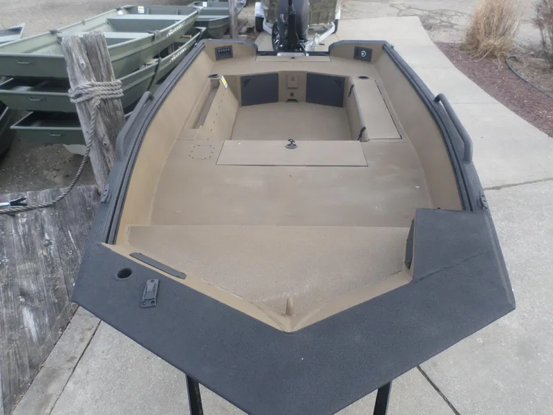 Slide: The Image of 2025 Excel 1651 River Warrior boat, spacious interior, docked on concrete surface. - 3